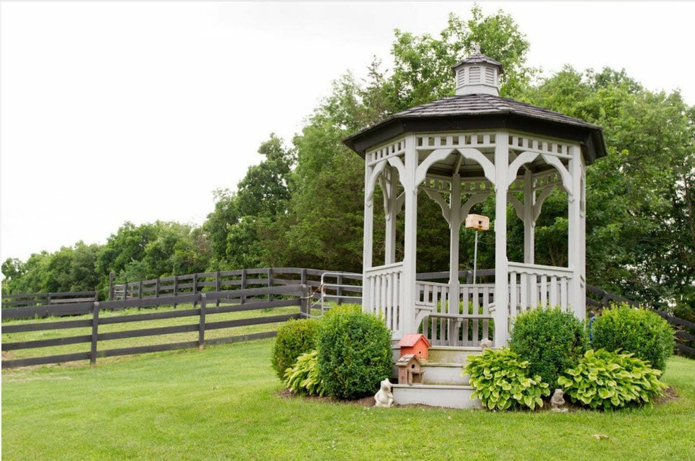 Wooden gazebo Rotunda on the hill of the site