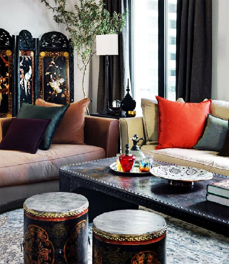 The coffee table is decorated with dishes and a tea set in an oriental style