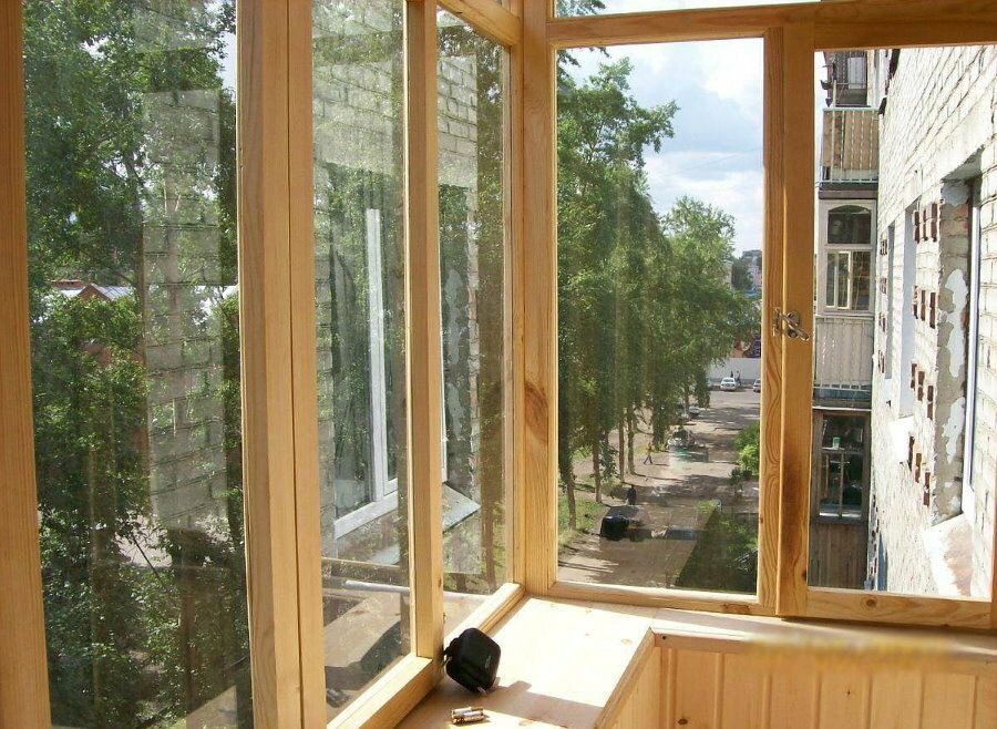 Khrushchev's balcony with wooden windows made of pine