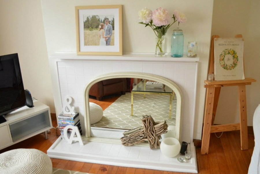 False fireplace with a mirror in a small living room