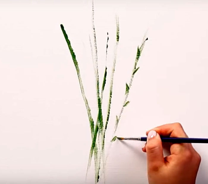 Desenhe caules e folhas na parede com um pincel. Use diferentes tons de verde para obter mais efeito.