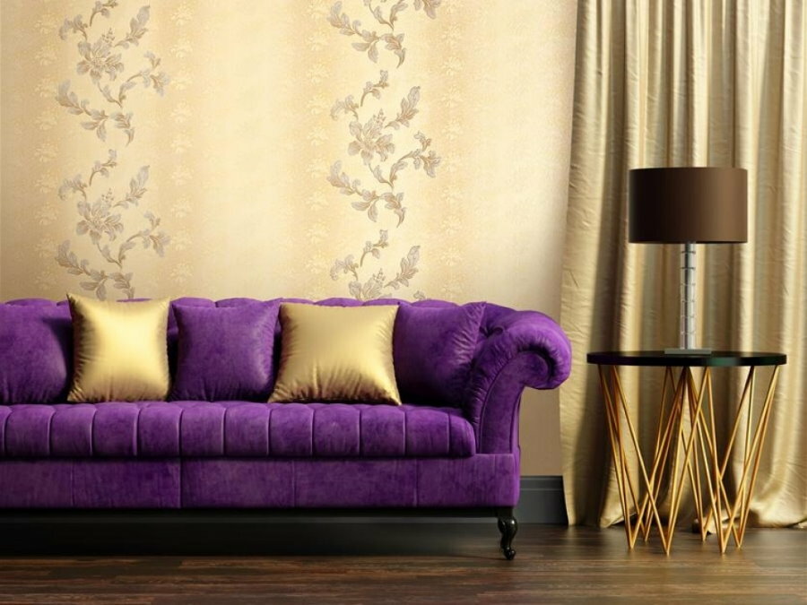 Vinyl wallpaper behind a purple sofa in the living room