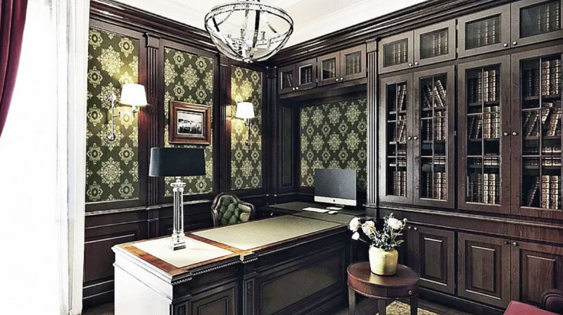 Gabinet rozświetla stylowy żyrandol z chromowaną ramą w formie półkuli i klasycznymi kinkietami z tkaninowymi kloszami