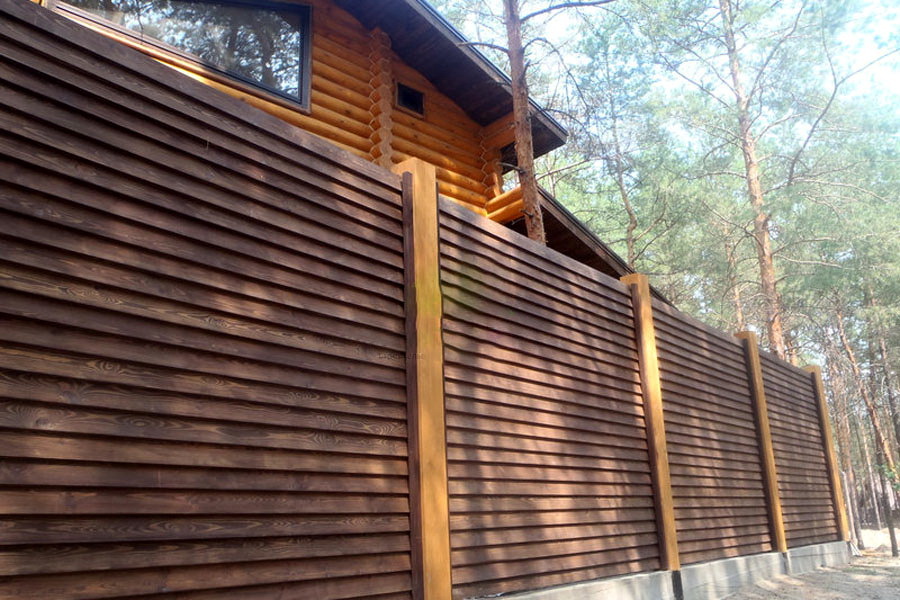 Solid fence of wooden blinds at their summer cottage
