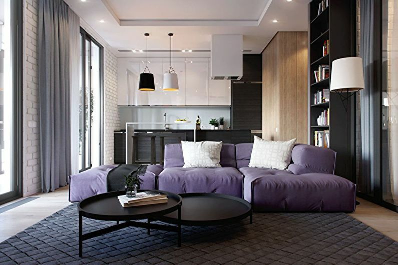 Liliowa sofa tapicerowana w kuchni-salonie
