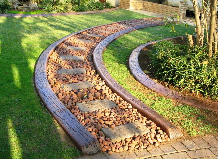 A chic stone walkway with wooden borders