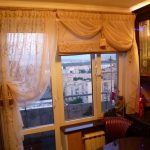 The combination of Roman blinds with curtains on the balcony window