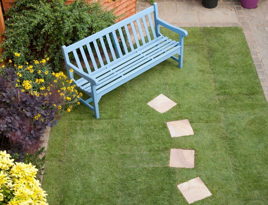 Step-by-step square tile path to garden bench