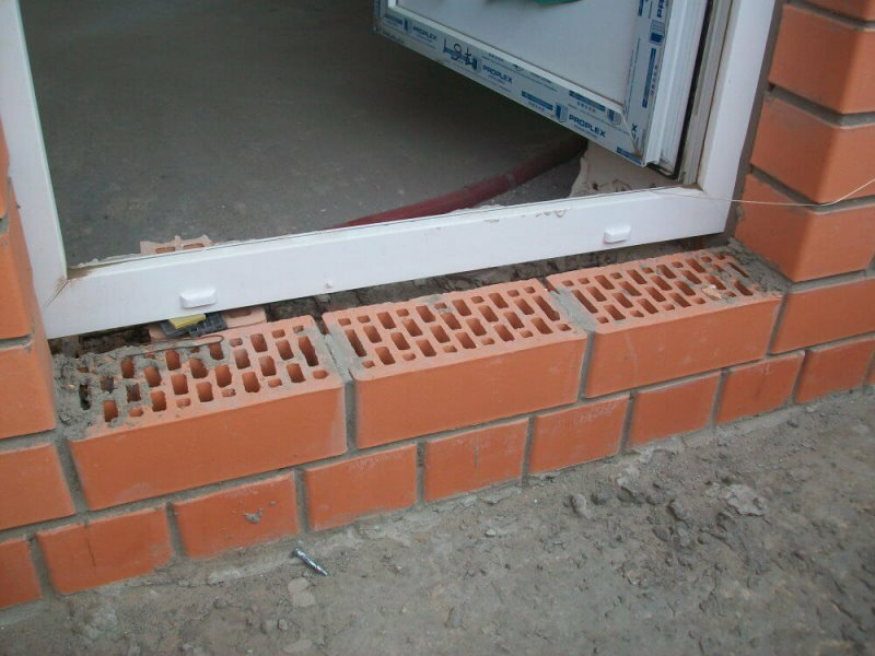 Masonry brick threshold in front of the balcony door