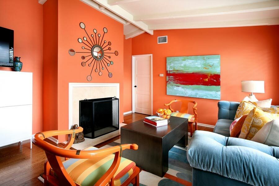 Bright painting of the walls in the living room with a blue sofa