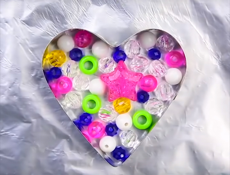 Stavite jedan sloj plastike. Odaberite najsvjetlije perle i gumbe, bit će zanimljivije.