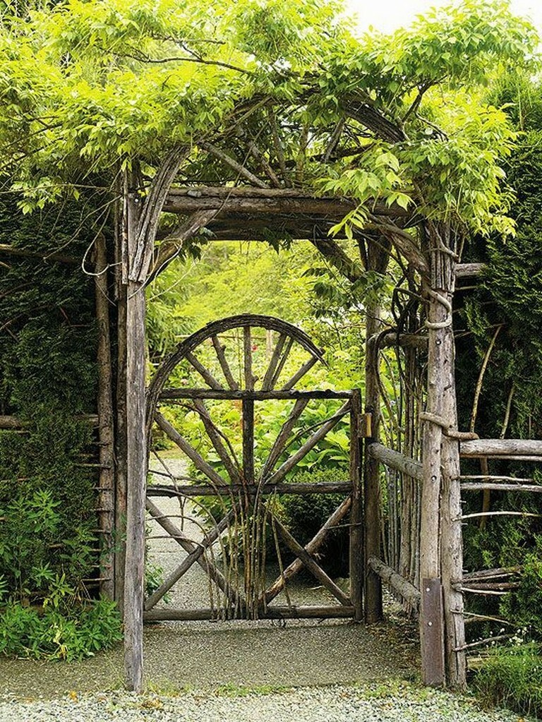 Overgrown arch above the wooden gate