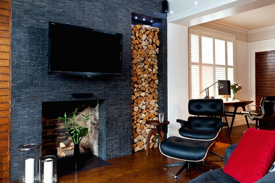 A stack of chopped firewood in a niche wall of the living room