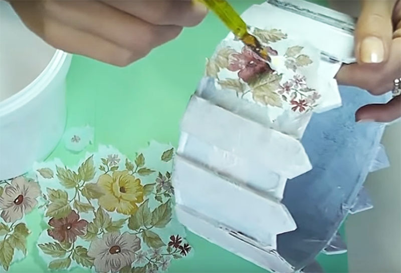 Place the drawing on a makeshift picket fence and paint over it with acrylic varnish using a paintbrush