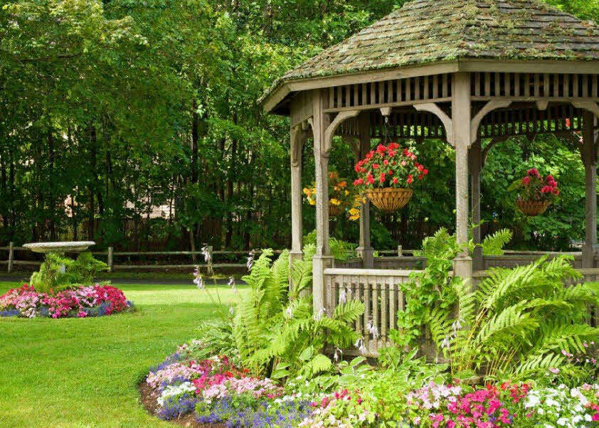 Old gazebo in a secluded corner of a garden site
