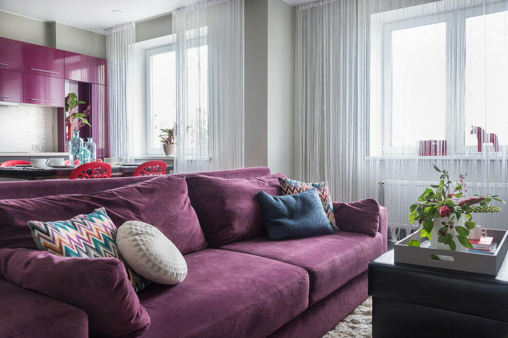 Pull-out sofa with fabric upholstery in purple tone