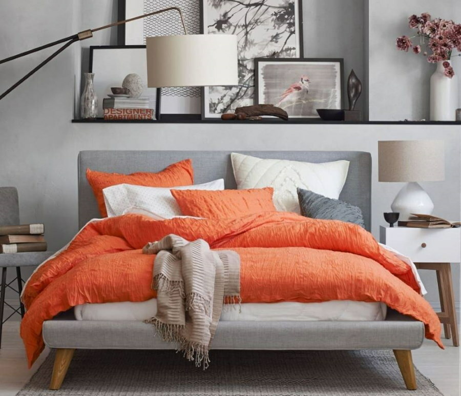 Bright bedspread on the bed with a gray headboard