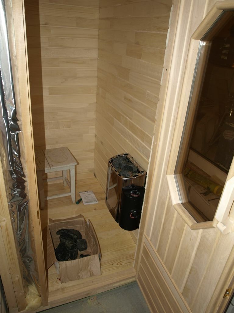 Compact stove-heater inside the sauna on the loggia