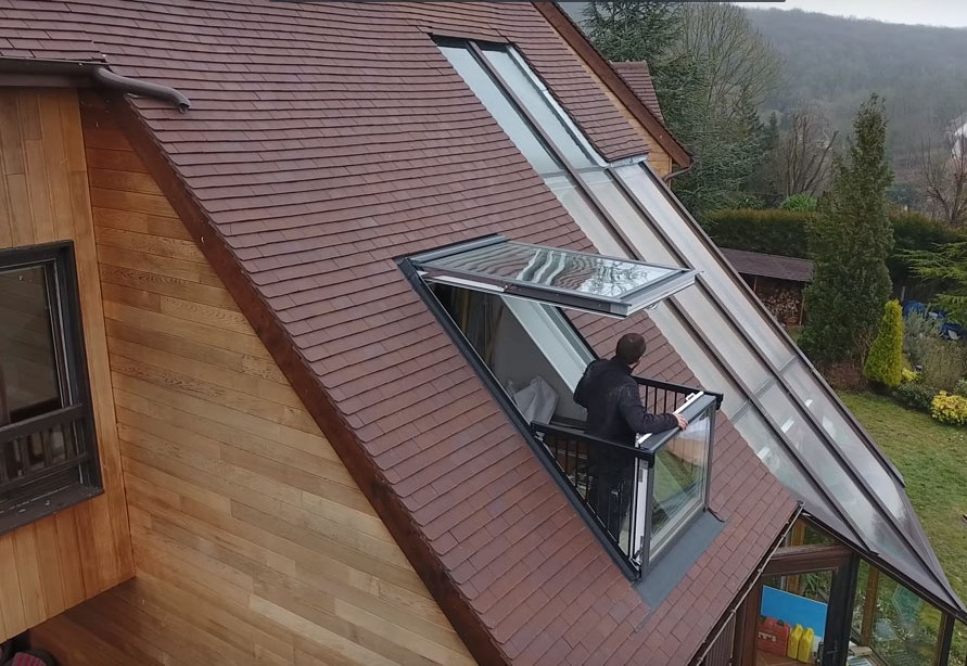 Balkongfönster på taket på vinden i ett privat hus
