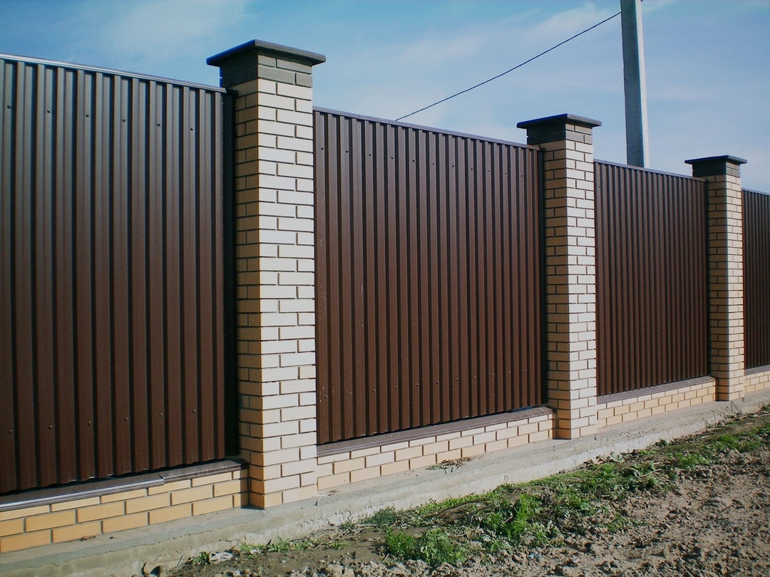 fence of corrugated with brick pillars