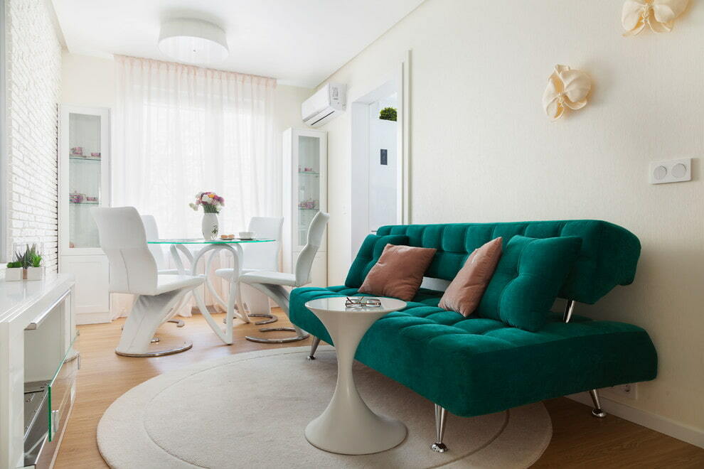 Green sofa in a bright dining-living room